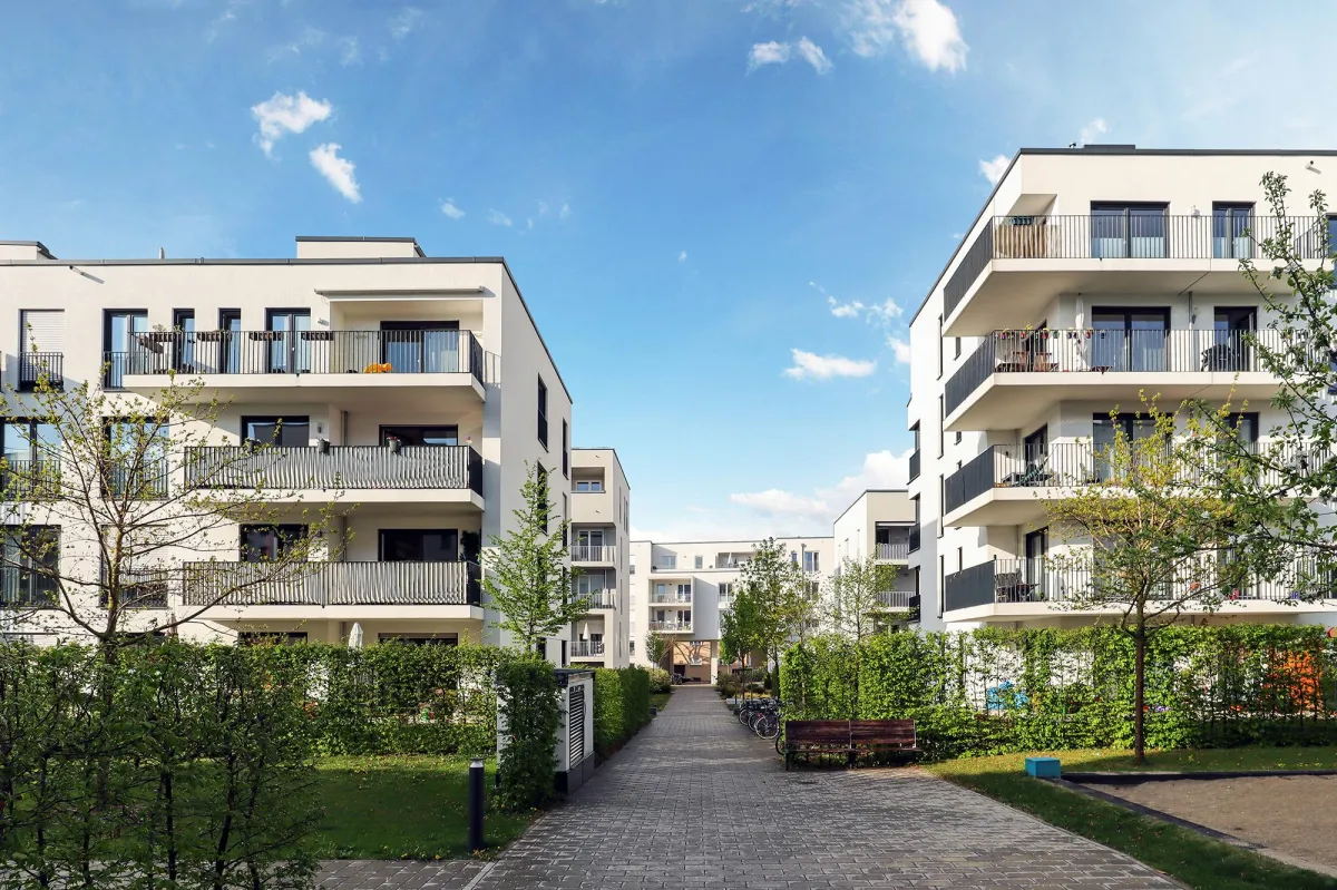Modern apartment buildings with clear blue sky.